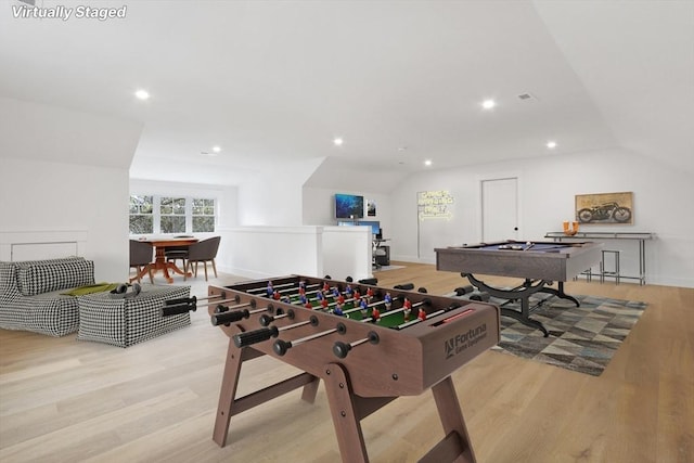 game room with lofted ceiling and light hardwood / wood-style flooring