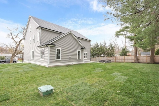 rear view of house with a lawn