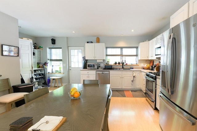 25 Taft St Unit 25, North Adams, MA 01247 - kitchen featuring appliances with stainless steel finishes, a sink, white cabinetry, recessed lighting, and light wood-style flooring