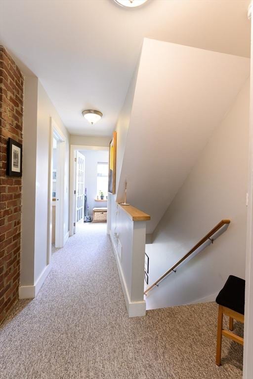 25 Taft St Unit 25, North Adams, MA 01247 - hall with an upstairs landing, light carpet, baseboards, and brick wall