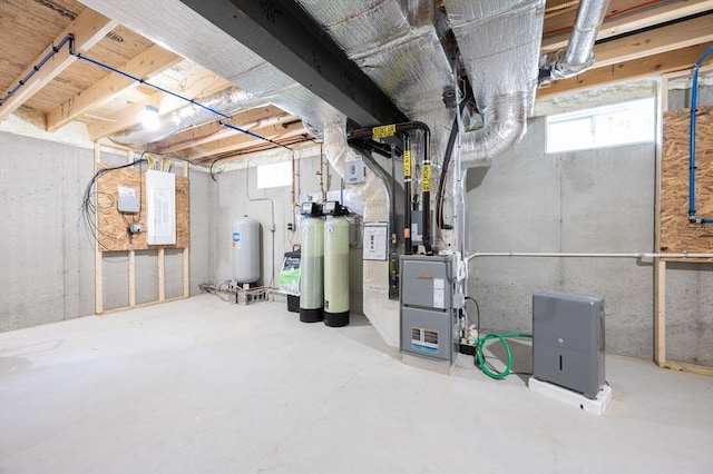 142 Tispaquin St, Middleboro, MA 02346 - basement featuring a water softener system, electric panel, heating unit, and a water pressure tank