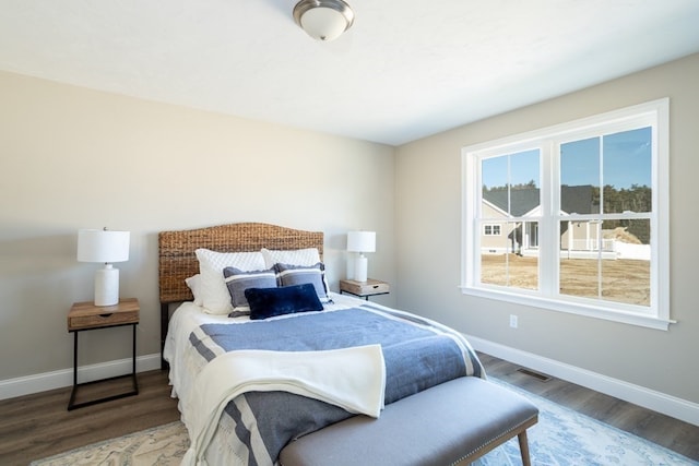 bedroom with hardwood / wood-style flooring