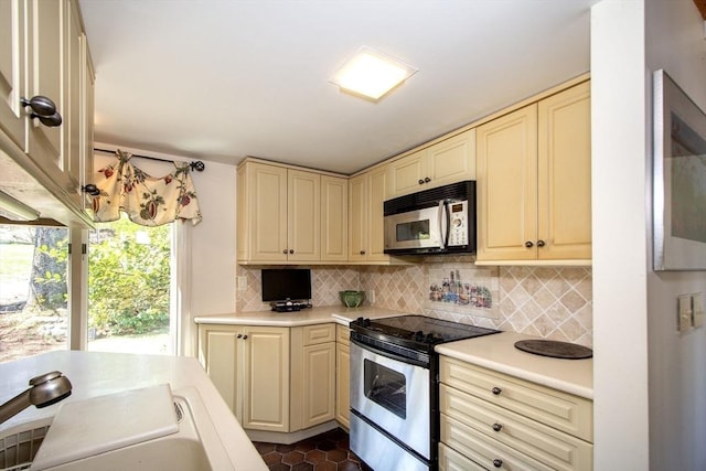 79 Myles View Dr, Duxbury, MA 02332 - kitchen featuring stainless steel appliances, cream cabinetry, light countertops, and backsplash