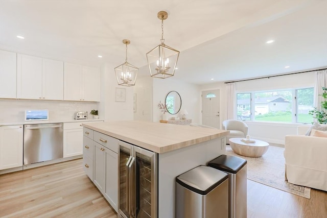 29 Regal St, Holliston, MA 01746 - kitchen with dishwasher, beverage cooler, light wood-style floors, a chandelier, and recessed lighting