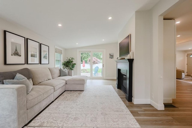 29 Regal St, Holliston, MA 01746 - living room featuring light wood finished floors, a glass covered fireplace, baseboards, recessed lighting, and vaulted ceiling