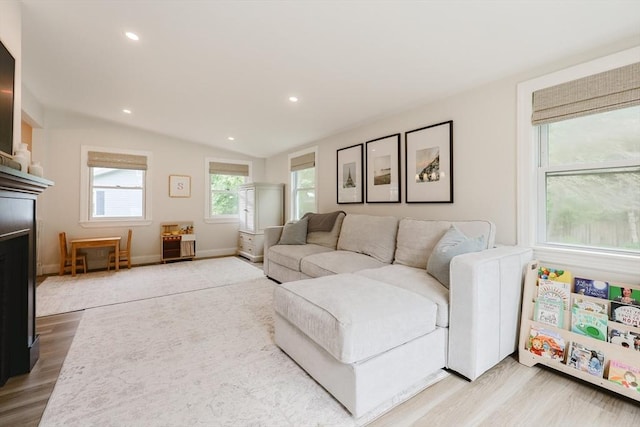 29 Regal St, Holliston, MA 01746 - living area with wood finished floors, vaulted ceiling, a fireplace, recessed lighting, and baseboards