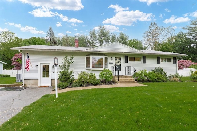 29 Regal St, Holliston, MA 01746 - view of front of property featuring a chimney, a front lawn, and cooling unit