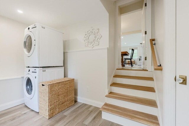 29 Regal St, Holliston, MA 01746 - washroom featuring stacked washer / dryer, light wood finished floors, baseboards, and recessed lighting