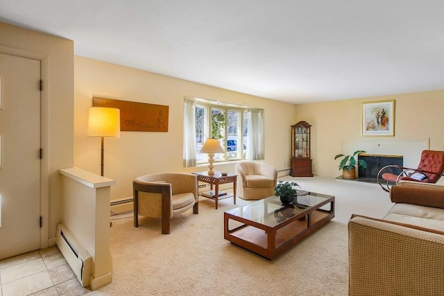 living area with a baseboard heating unit, a fireplace with raised hearth, and light colored carpet