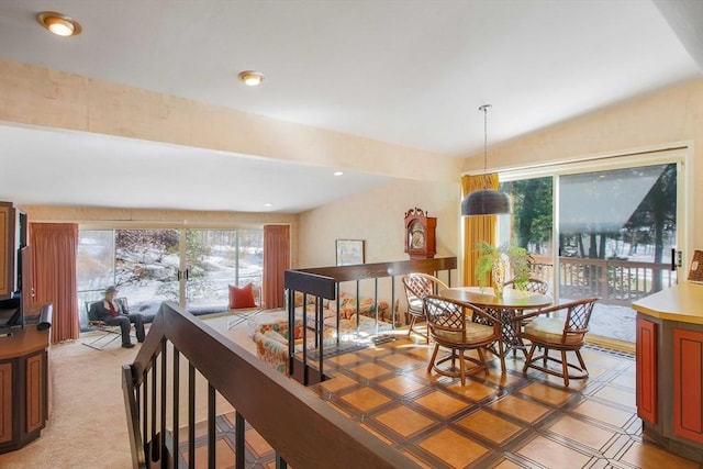 dining space with vaulted ceiling and a healthy amount of sunlight