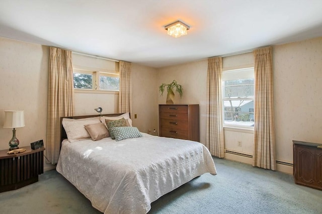 bedroom with baseboard heating and light colored carpet