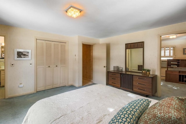 carpeted bedroom featuring a closet and baseboards