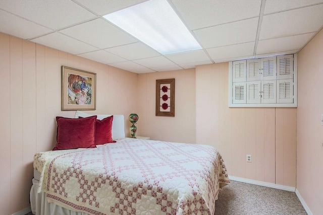 carpeted bedroom with a drop ceiling