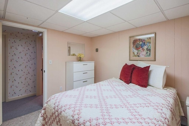 bedroom with carpet floors and a drop ceiling