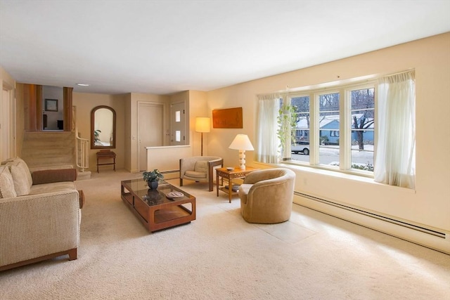 living area featuring baseboard heating and carpet flooring