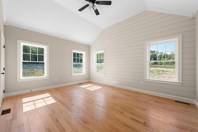 spare room with ornamental molding, lofted ceiling, and light wood-type flooring