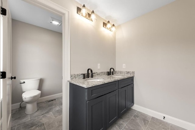 bathroom featuring vanity and toilet