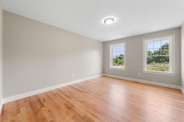 spare room with light hardwood / wood-style flooring