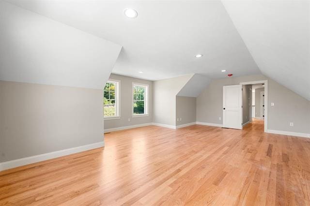 bonus room featuring lofted ceiling and light wood-type flooring