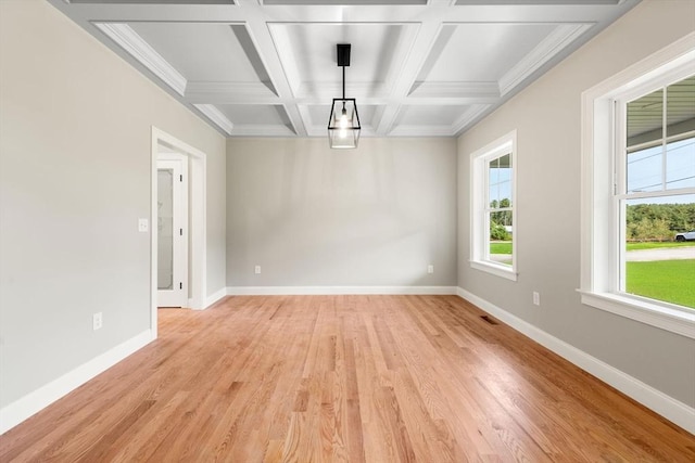 unfurnished dining area featuring coffered ceiling, beam ceiling, and light hardwood / wood-style flooring