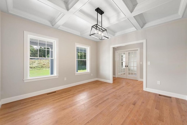 unfurnished dining area with beam ceiling, coffered ceiling, ornamental molding, light hardwood / wood-style floors, and french doors