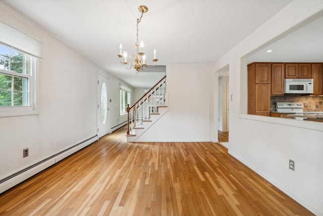 103 Central St, Newbury, MA 01922 - unfurnished living room with a baseboard radiator, a chandelier, light wood finished floors, stairs, and recessed lighting