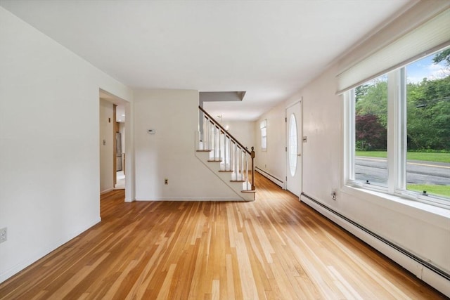 103 Central St, Newbury, MA 01922 - entryway with a baseboard heating unit, light wood-style flooring, and stairway