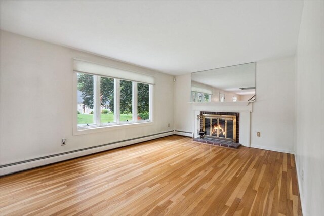 103 Central St, Newbury, MA 01922 - unfurnished living room featuring wood finished floors, a fireplace, and baseboard heating