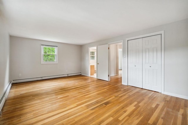 103 Central St, Newbury, MA 01922 - unfurnished bedroom featuring light wood-type flooring, baseboard heating, and a closet