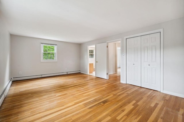103 Central St, Newbury, MA 01922 - unfurnished bedroom featuring light wood finished floors, a baseboard radiator, and a closet