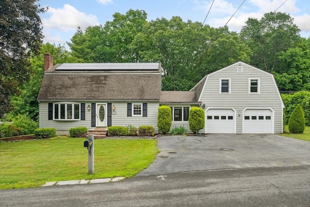 103 Central St, Newbury, MA 01922 - dutch colonial featuring a gambrel roof, asphalt driveway, roof with shingles, roof mounted solar panels, and a front lawn