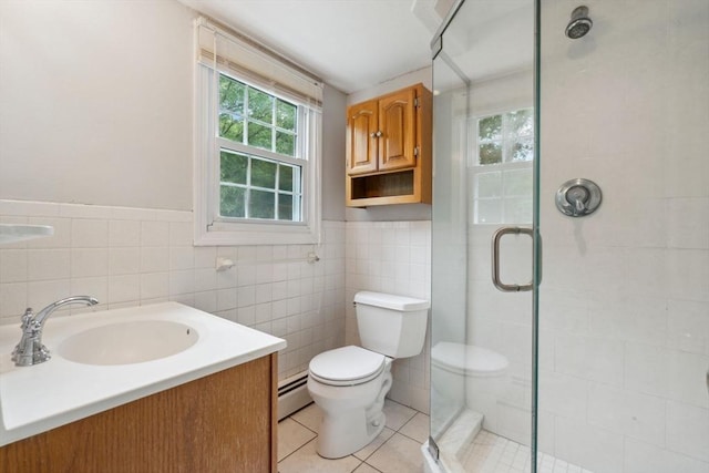 103 Central St, Newbury, MA 01922 - bathroom featuring baseboard heating, a stall shower, tile walls, tile patterned flooring, and vanity