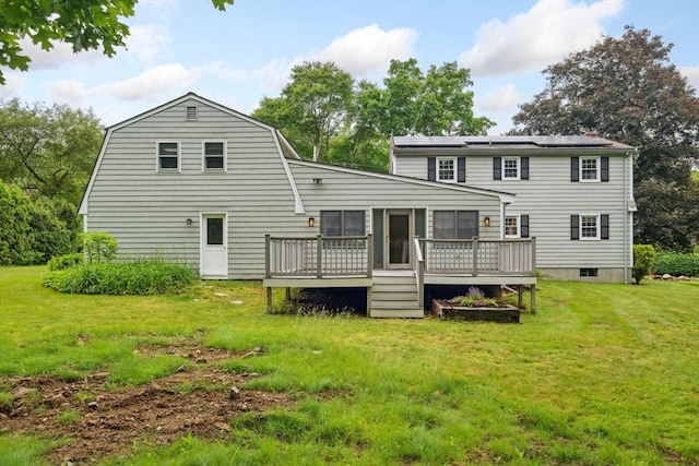 103 Central St, Newbury, MA 01922 - back of house featuring a deck, a lawn, solar panels, and a sunroom