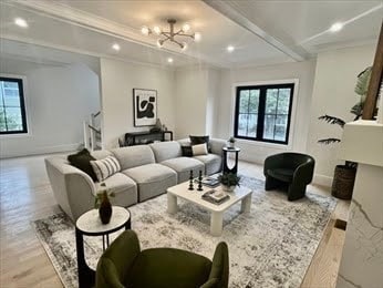 living room featuring french doors, an inviting chandelier, light hardwood / wood-style floors, and ornamental molding