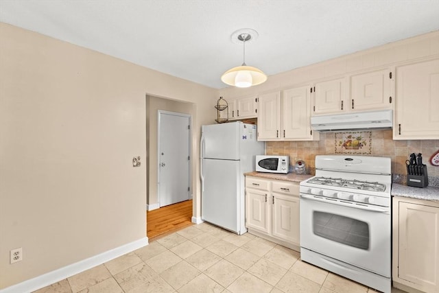 114 Cypress Dr, Swansea, MA 02777 - kitchen featuring under cabinet range hood, white appliances, light countertops, backsplash, and hanging light fixtures