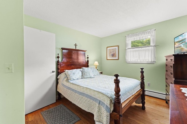 114 Cypress Dr, Swansea, MA 02777 - bedroom featuring baseboard heating and wood finished floors