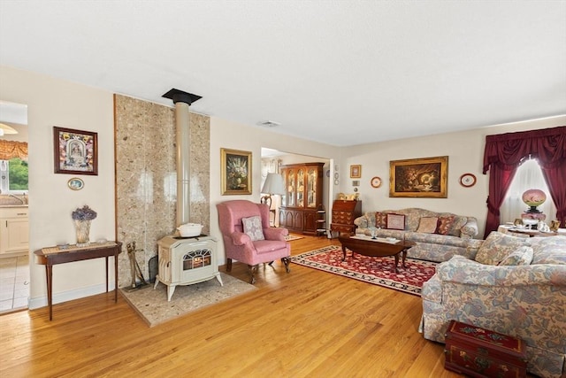 114 Cypress Dr, Swansea, MA 02777 - living area with a wood stove and light wood finished floors