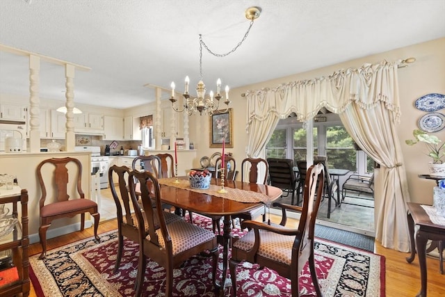 114 Cypress Dr, Swansea, MA 02777 - dining room featuring a chandelier, healthy amount of natural light, and light wood finished floors