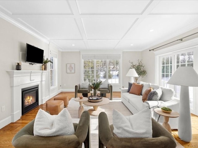 living room featuring coffered ceiling, a wealth of natural light, and light hardwood / wood-style floors