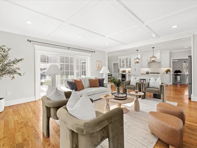 living room with ornamental molding, coffered ceiling, and light hardwood / wood-style floors