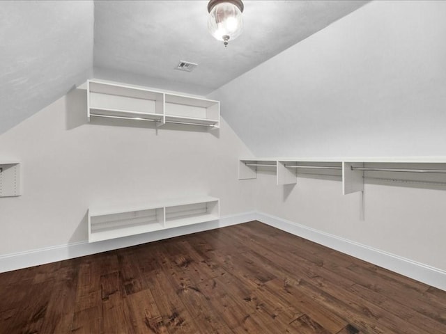 walk in closet featuring lofted ceiling and hardwood / wood-style floors