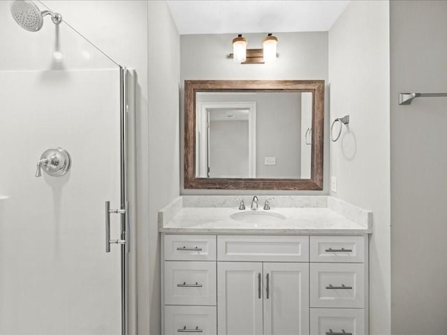 bathroom with vanity and a shower with shower door