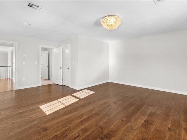 unfurnished room with dark hardwood / wood-style flooring