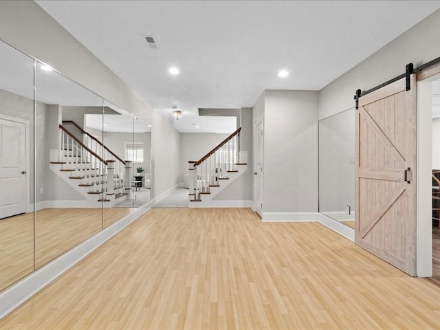 interior space featuring hardwood / wood-style flooring and a barn door