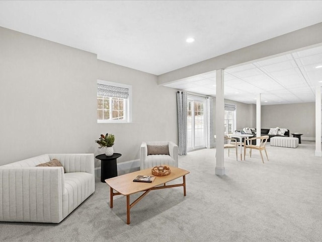 living room with light colored carpet and a healthy amount of sunlight