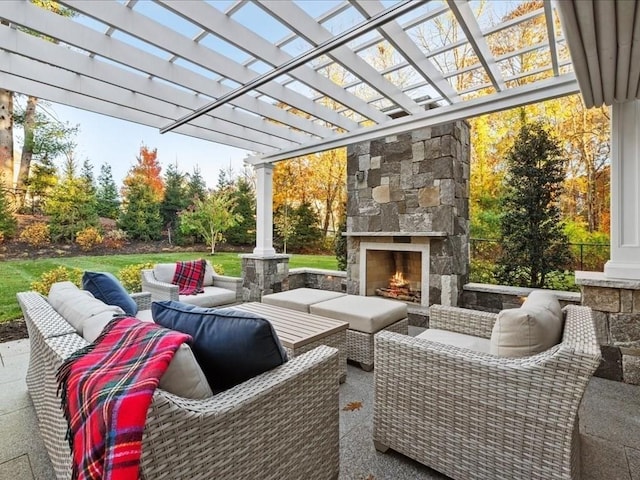 view of patio / terrace with an outdoor living space with a fireplace and a pergola