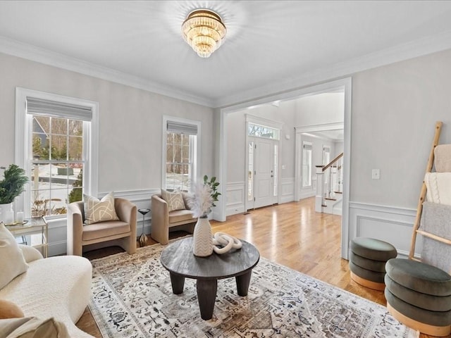 living room featuring crown molding and light wood-type flooring