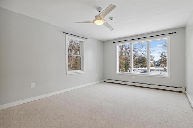 carpeted empty room with a baseboard heating unit and ceiling fan