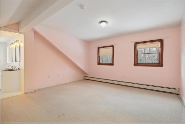 bonus room with lofted ceiling with beams, light carpet, and a baseboard heating unit