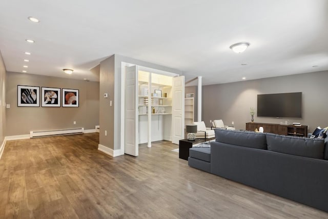 living room with baseboard heating and hardwood / wood-style floors